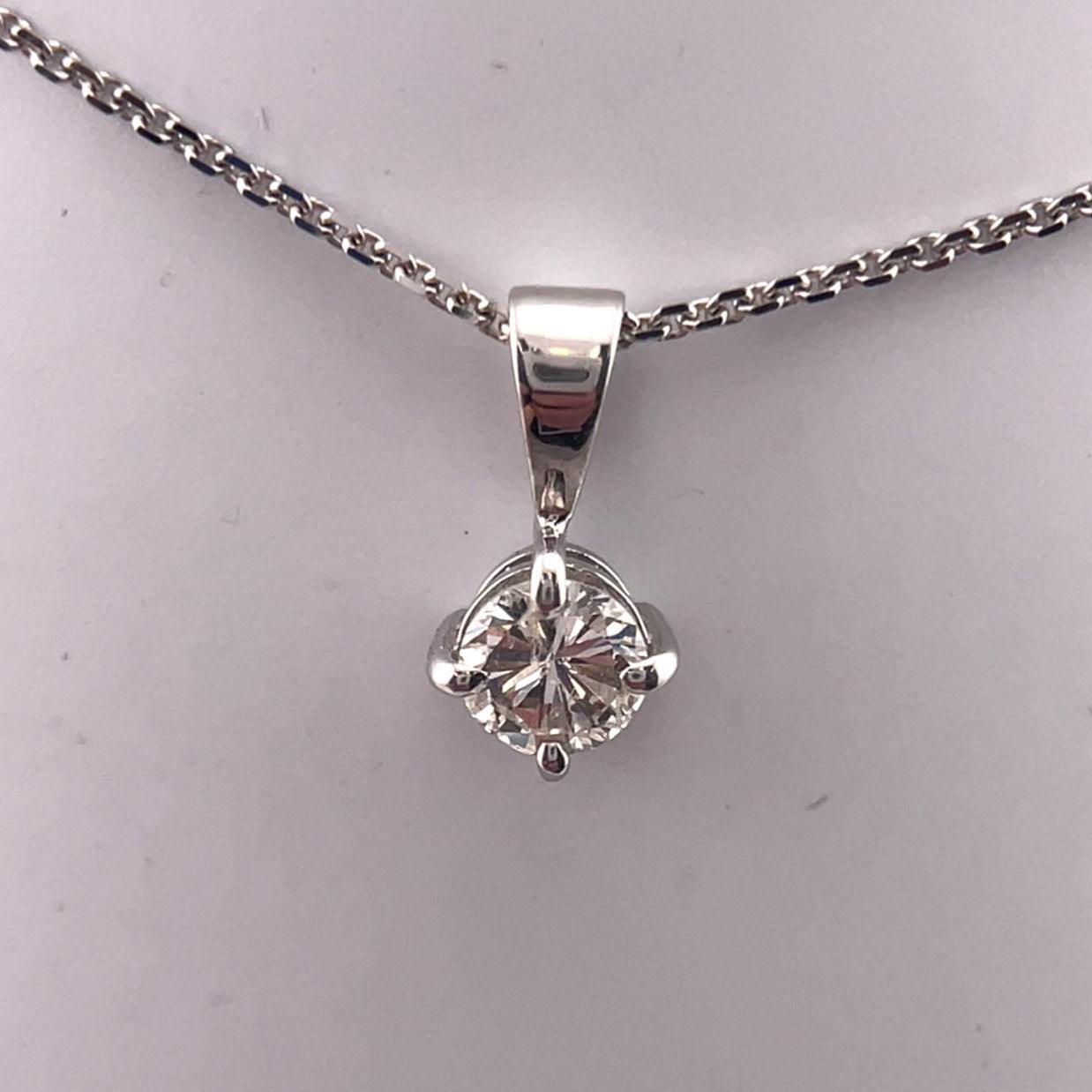 Diamond necklace with 0.34ct round natural brilliant cut diamond set in a simple 4 claw pendent in 18ct white gold including a 18'' white gold chain.