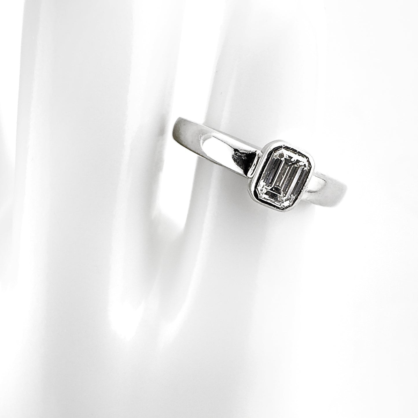 Emerald cut diamond rubover ring, platinum