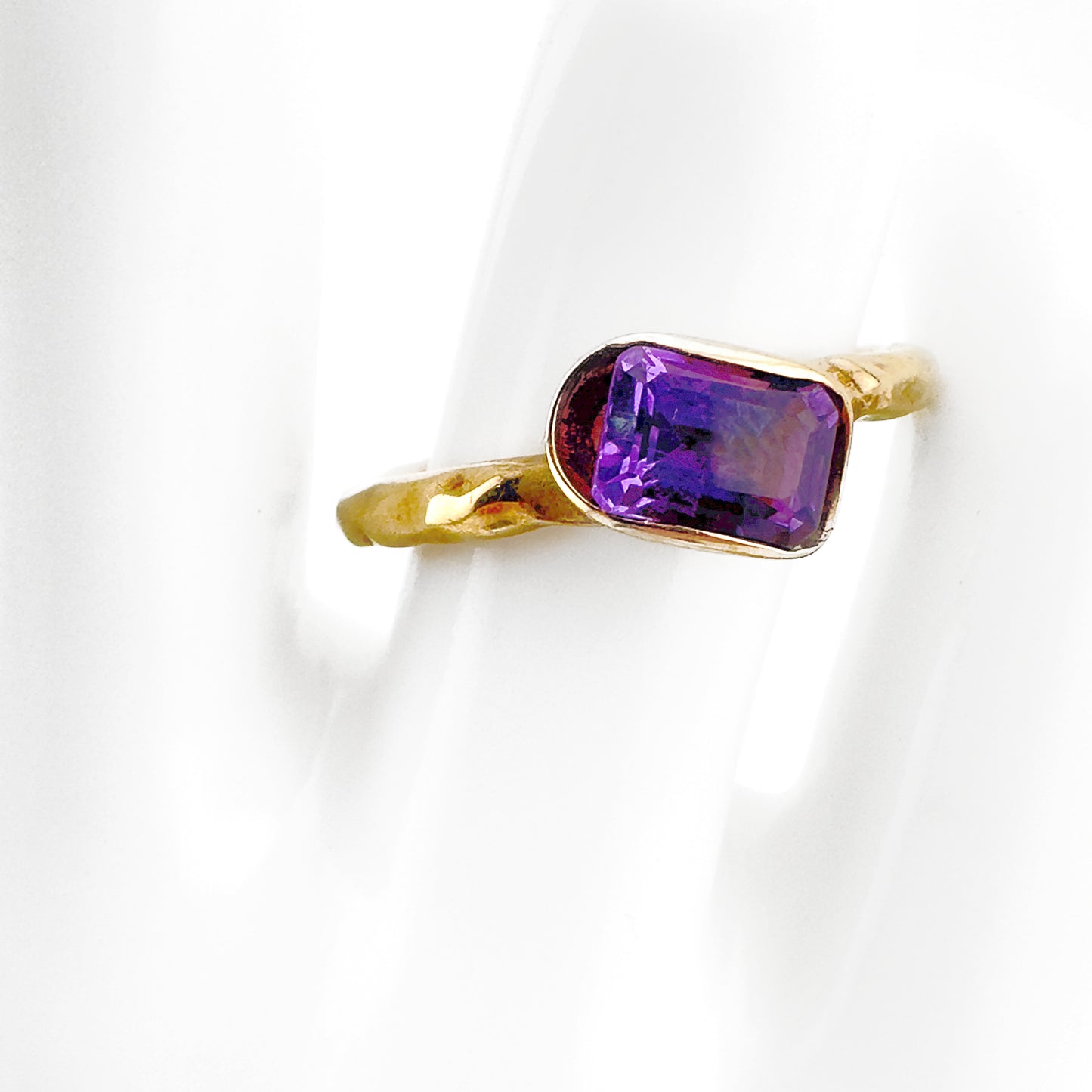 Tilted amethyst ring, 9ct yellow gold with hammered finish to band